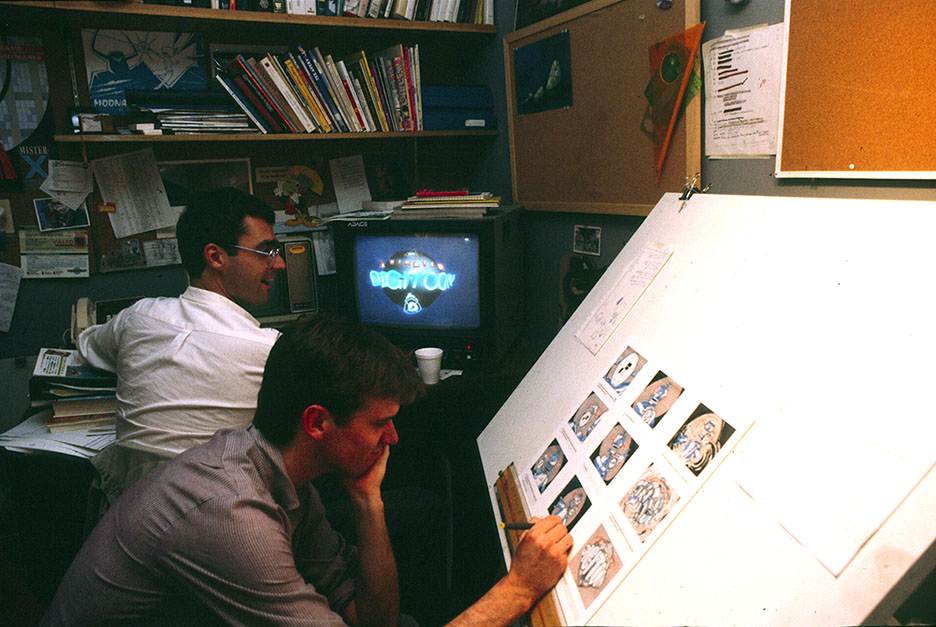 Two people at an animation workstation.